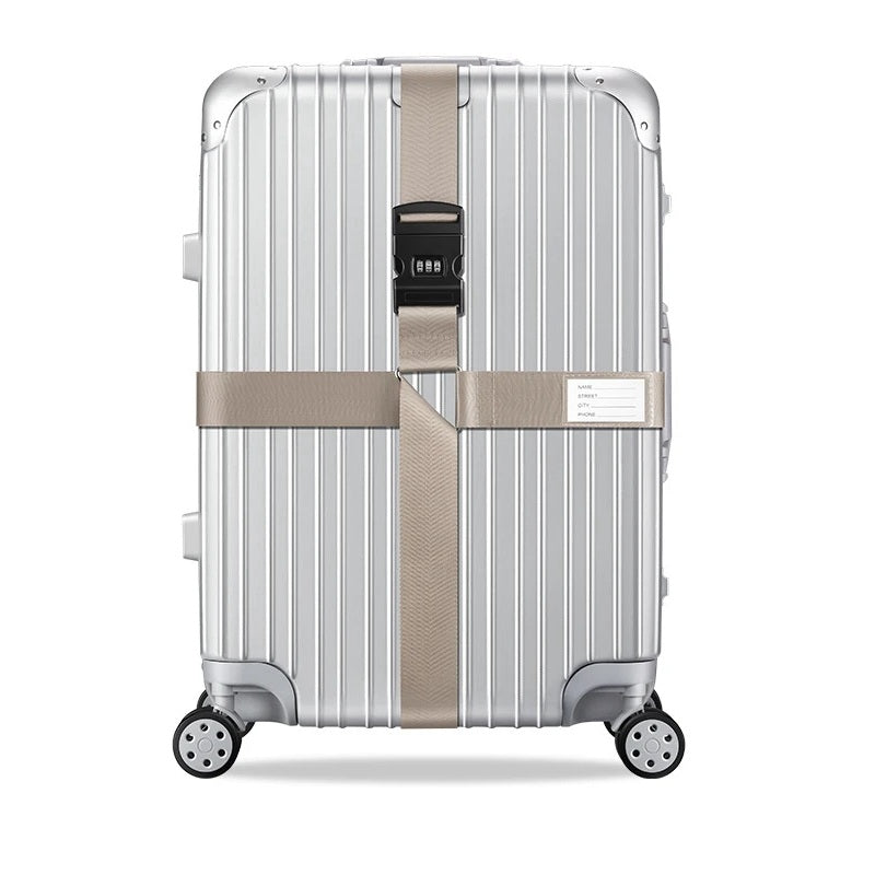 Sangle pour valise croisée antivol à code fixée sur une valise rigide argent, utilisée en situation réelle dans un aéroport, avec poignée télescopique tirée par un voyageur. khaki